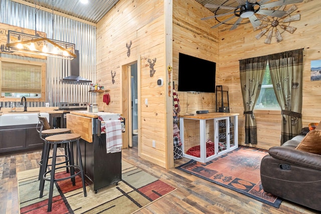 1780 Wolf Haven Rd, Spencer, TN 38585 - kitchen with wooden walls, wall chimney range hood, a ceiling fan, open floor plan, and a high ceiling