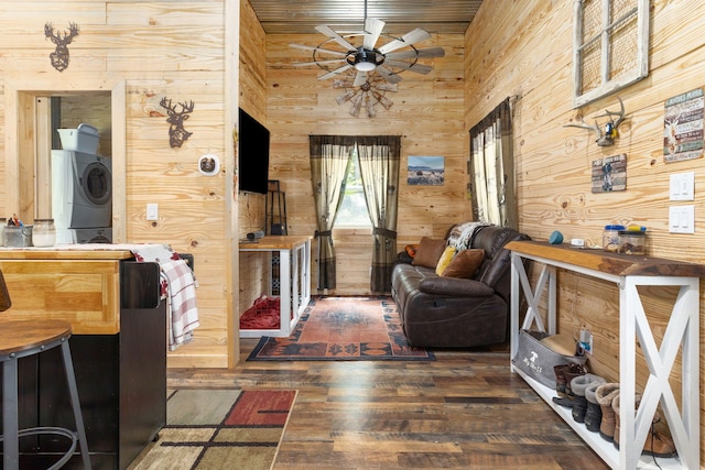 1780 Wolf Haven Rd, Spencer, TN 38585 - living room featuring stacked washer / dryer, wooden walls, ceiling fan, and hardwood / wood-style floors