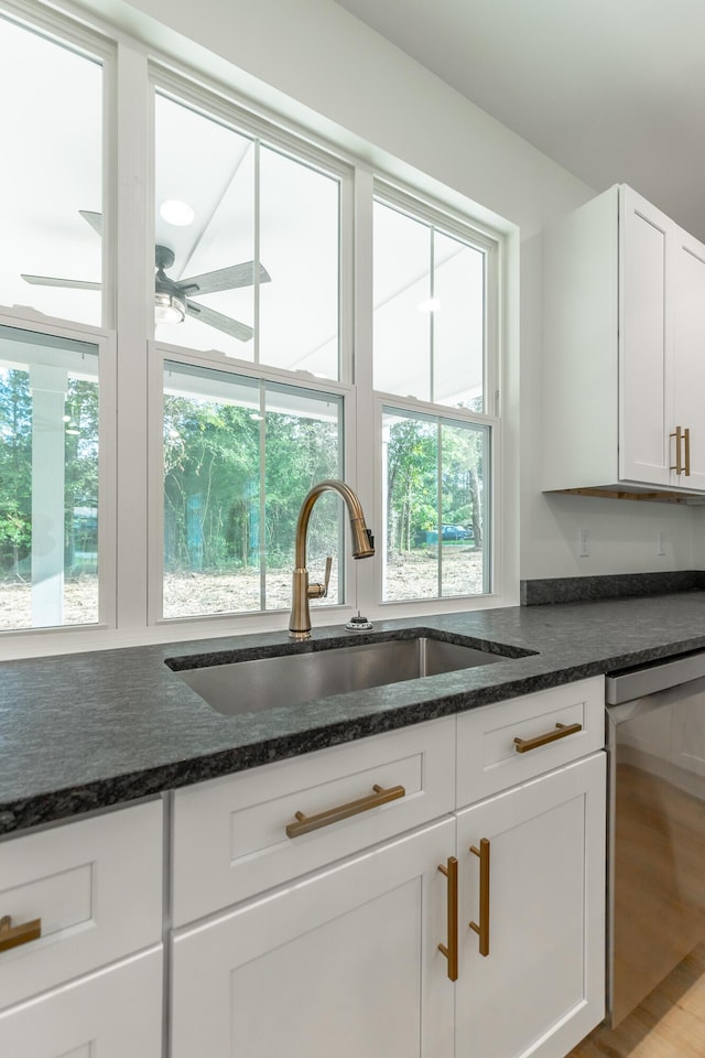 581 W Reed Rd, Lafayette, GA 30728 - kitchen with stainless steel dishwasher, white cabinets, dark stone counters, and wood finished floors