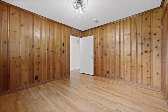 3712 Norma Dr, Chattanooga, TN 37412 - empty room featuring wood finished floors, wood walls, ornamental molding, and a textured ceiling