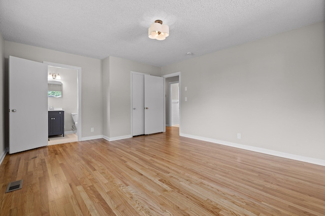 3712 Norma Dr, Chattanooga, TN 37412 - unfurnished bedroom with light wood-style flooring, a textured ceiling, and ensuite bathroom