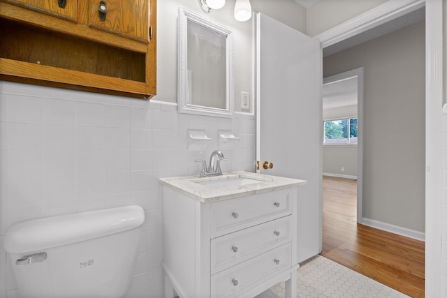 3712 Norma Dr, Chattanooga, TN 37412 - half bath featuring vanity, wood finished floors, and tile walls