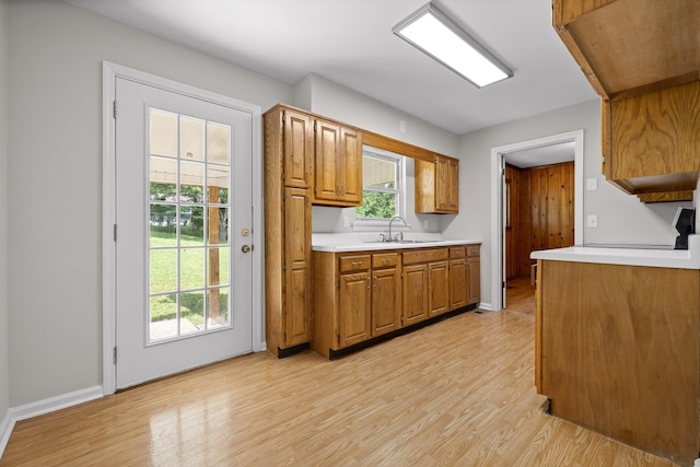 3712 Norma Dr, Chattanooga, TN 37412 - kitchen with light wood finished floors, light countertops, brown cabinets, and stove