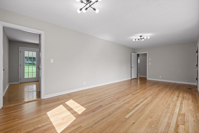 3712 Norma Dr, Chattanooga, TN 37412 - spare room with a chandelier and light wood-style flooring