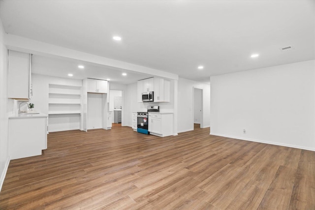 1320 Coker Dr, Dalton, GA 30721 - unfurnished living room featuring light wood finished floors, recessed lighting, and built in features