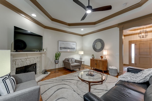 2742 Amsterdam Ln Unit 14, Chattanooga, TN 37421 - living room featuring a raised ceiling, ornamental molding, wood finished floors, a stone fireplace, and ceiling fan