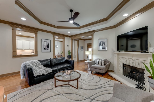 2742 Amsterdam Ln Unit 14, Chattanooga, TN 37421 - living room featuring crown molding, a tray ceiling, a ceiling fan, wood finished floors, and a brick fireplace