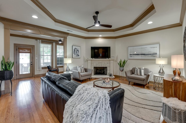 2742 Amsterdam Ln Unit 14, Chattanooga, TN 37421 - living room featuring ceiling fan, a raised ceiling, crown molding, a fireplace with raised hearth, and light wood finished floors