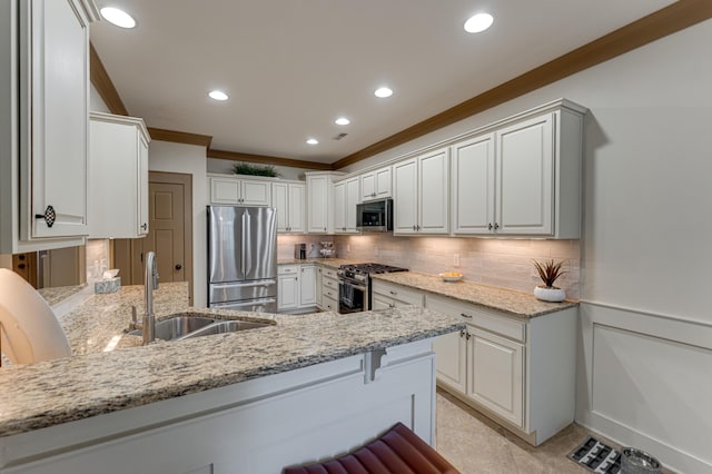 2742 Amsterdam Ln Unit 14, Chattanooga, TN 37421 - kitchen featuring appliances with stainless steel finishes, ornamental molding, light stone countertops, tasteful backsplash, and a peninsula