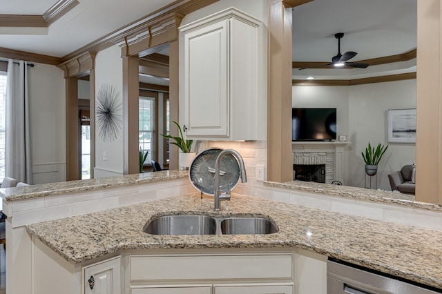 2742 Amsterdam Ln Unit 14, Chattanooga, TN 37421 - kitchen with crown molding, a ceiling fan, healthy amount of natural light, light stone counters, and a fireplace