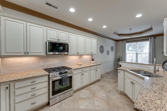 2742 Amsterdam Ln Unit 14, Chattanooga, TN 37421 - kitchen with stainless steel gas range oven, crown molding, a decorative wall, decorative backsplash, and hanging light fixtures