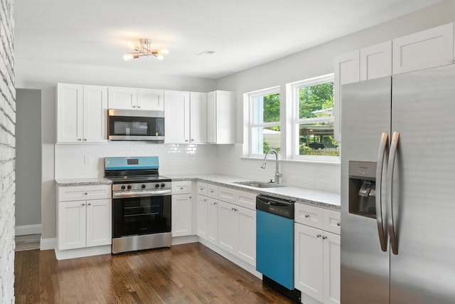 2207 Spencer Ave, Chattanooga, TN 37421 - kitchen featuring appliances with stainless steel finishes, backsplash, a chandelier, white cabinetry, and light stone counters