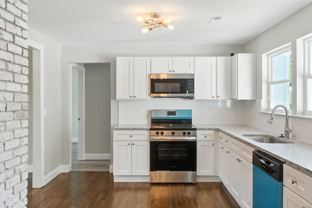 2207 Spencer Ave, Chattanooga, TN 37421 - kitchen with appliances with stainless steel finishes, tasteful backsplash, a chandelier, and white cabinetry