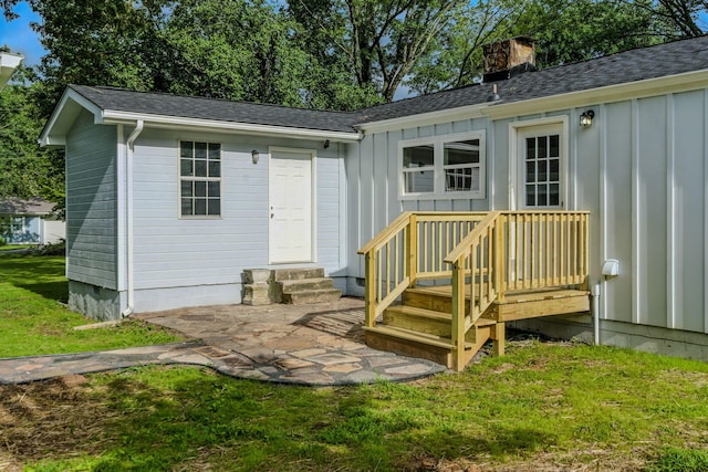 2207 Spencer Ave, Chattanooga, TN 37421 - back of property featuring board and batten siding, a chimney, a shingled roof, and a lawn