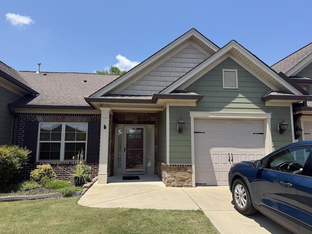 5478 Mandarin Cir, Hixson, TN 37343 - view of front of property featuring an attached garage, roof with shingles, driveway, and stone siding