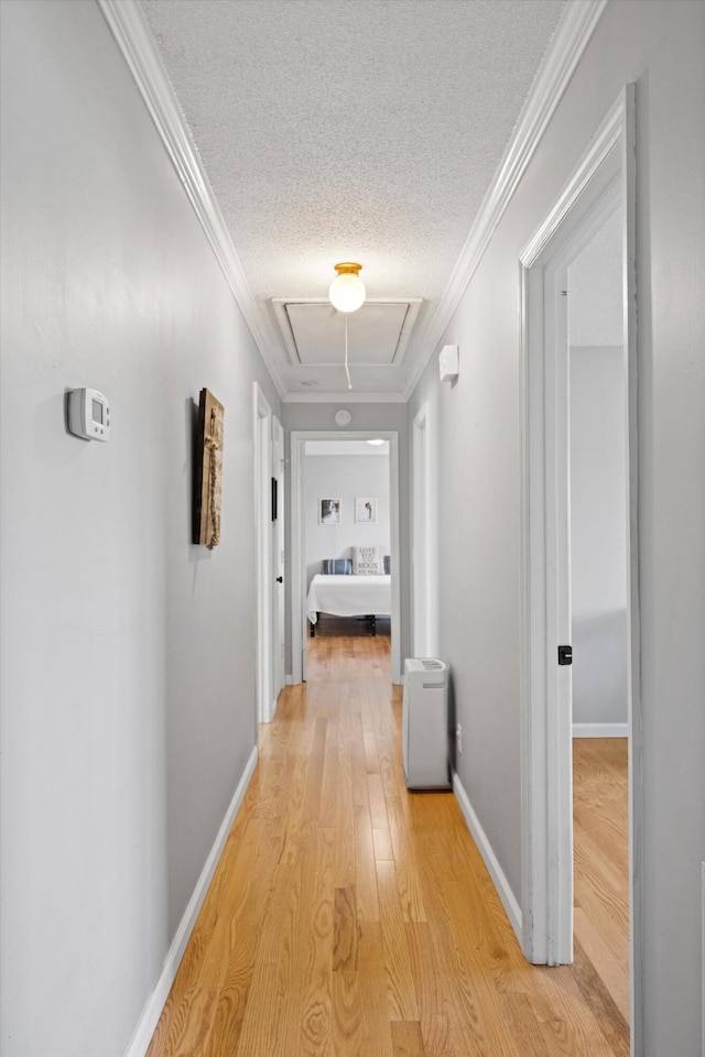 119 Broadacre Rd NE, Dalton, GA 30721 - hallway with attic access, light wood-style flooring, a textured ceiling, and crown molding