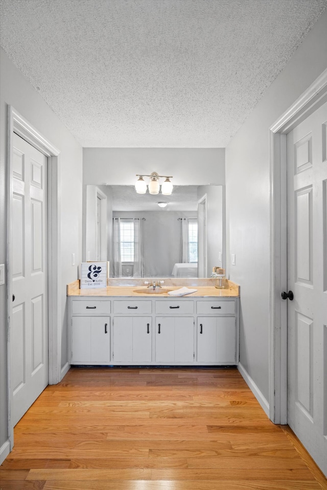 119 Broadacre Rd NE, Dalton, GA 30721 - bathroom with vanity, a textured ceiling, and wood finished floors
