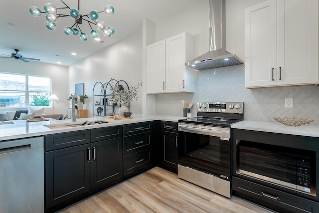 1857 Zeta Way, Chattanooga, TN 37404 - kitchen with appliances with stainless steel finishes, wall chimney range hood, white cabinetry, and light countertops