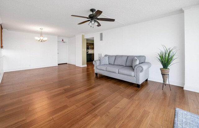 1131 Stringers Ridge Rd Unit 4C, Chattanooga, TN 37405 - living area with a chandelier, a ceiling fan, wood finished floors, crown molding, and a textured ceiling