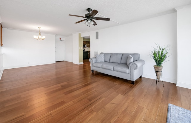 1131 Stringers Ridge Rd Unit 4C, Chattanooga, TN 37405 - living area with a chandelier, a ceiling fan, wood finished floors, crown molding, and a textured ceiling