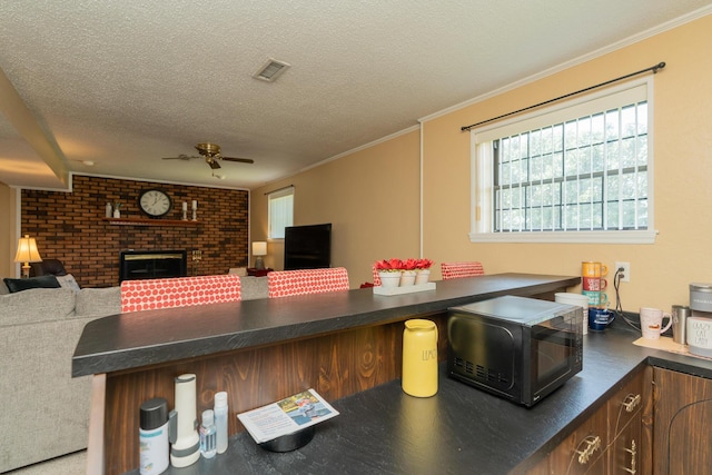 1510 Cannon Dr, Fort Oglethorpe, GA 30742 - kitchen with ceiling fan, black microwave, dark countertops, open floor plan, and a textured ceiling