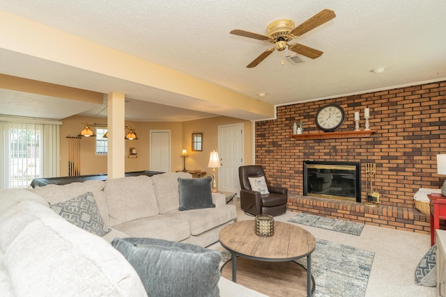 1510 Cannon Dr, Fort Oglethorpe, GA 30742 - carpeted living area with a ceiling fan, a textured ceiling, and a brick fireplace