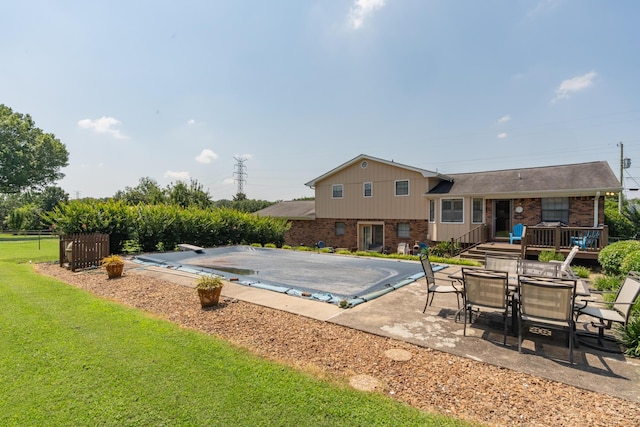 1510 Cannon Dr, Fort Oglethorpe, GA 30742 - view of pool featuring a diving board, a patio area, a covered pool, a deck, and a lawn