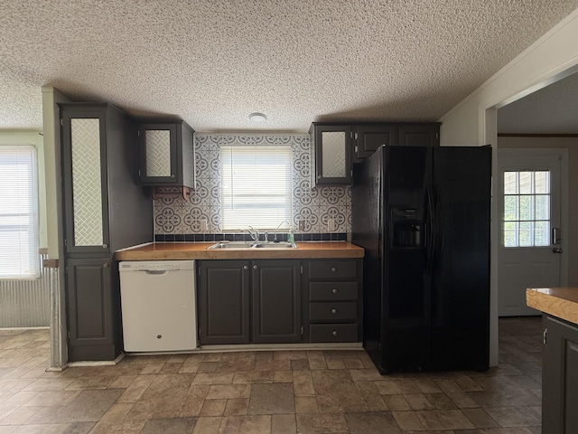 2487 Corinth Rd, Lafayette, GA 30728 - kitchen featuring white dishwasher, black fridge, a textured ceiling, plenty of natural light, and light stone finish flooring