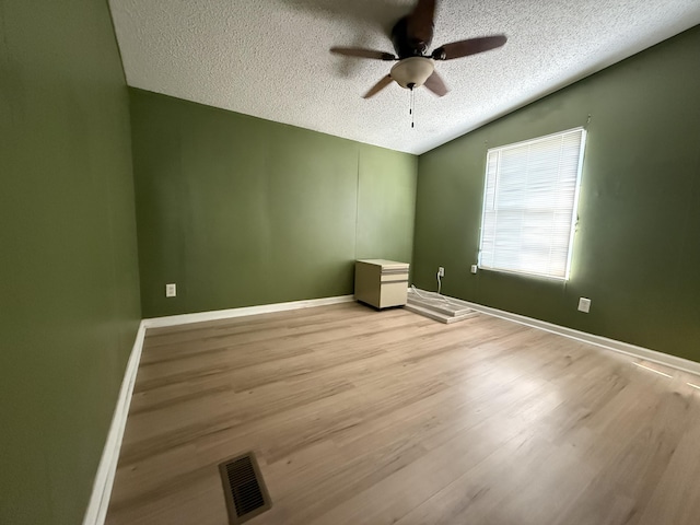 2487 Corinth Rd, Lafayette, GA 30728 - unfurnished room featuring a textured ceiling, ceiling fan, vaulted ceiling, and wood finished floors