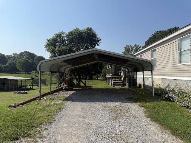 2487 Corinth Rd, Lafayette, GA 30728 - view of vehicle parking featuring a detached carport, gravel driveway, and stairs