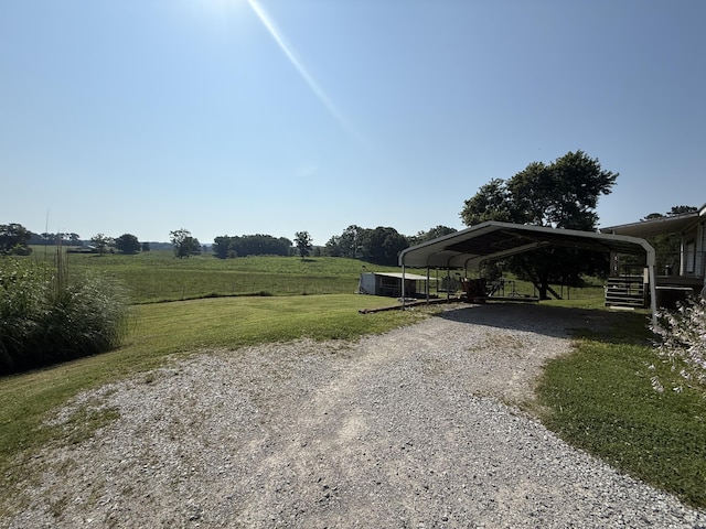 2487 Corinth Rd, Lafayette, GA 30728 - view of green lawn with gravel driveway, a detached carport, and a view of countryside