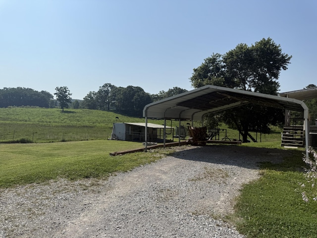 2487 Corinth Rd, Lafayette, GA 30728 - view of parking / parking lot featuring gravel driveway, a carport, and a rural view