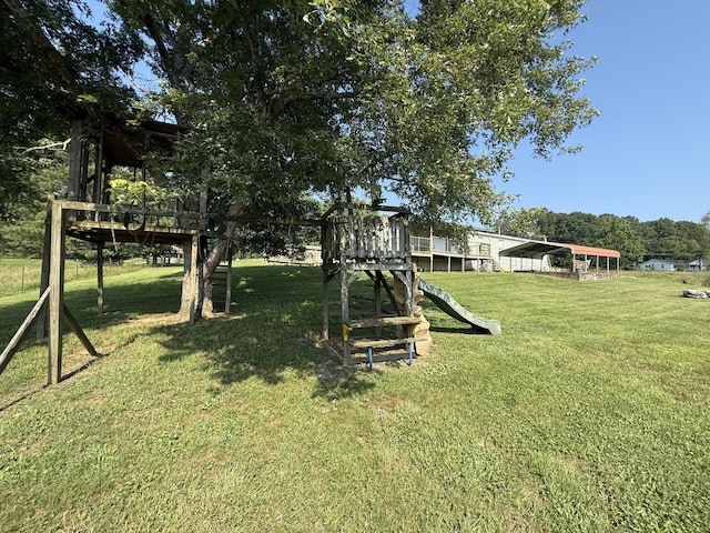2487 Corinth Rd, Lafayette, GA 30728 - view of grassy yard featuring a carport and a playground