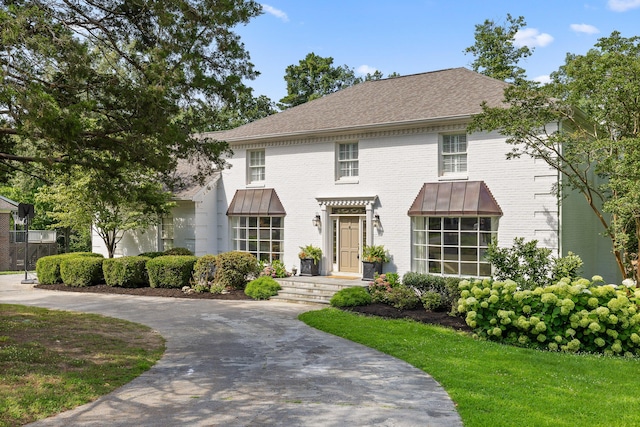9420 Mountain Shadows Dr, Chattanooga, TN 37421 - georgian-style home with brick siding, curved driveway, and a shingled roof
