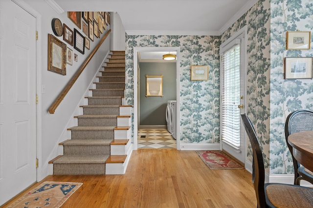 9420 Mountain Shadows Dr, Chattanooga, TN 37421 - foyer featuring wallpapered walls, wood finished floors, stairs, crown molding, and washer and dryer