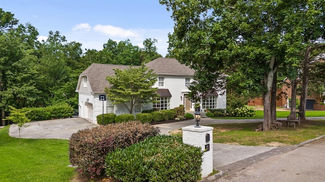 9420 Mountain Shadows Dr, Chattanooga, TN 37421 - view of property hidden behind natural elements featuring a garage, a front lawn, a shingled roof, and driveway