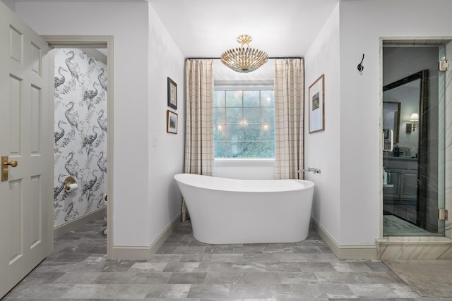 9420 Mountain Shadows Dr, Chattanooga, TN 37421 - bathroom with a soaking tub, a chandelier, and a stall shower