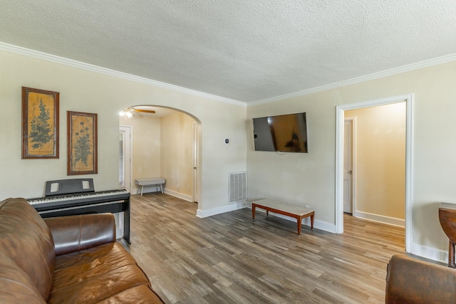 1602 Prater Rd, Chattanooga, TN 37412 - living room with arched walkways, wood finished floors, a textured ceiling, and crown molding