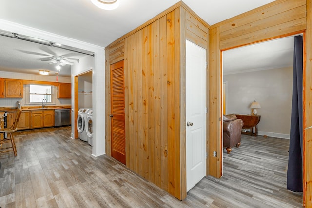 1602 Prater Rd, Chattanooga, TN 37412 - hallway featuring washing machine and dryer, light wood finished floors, ornamental molding, and wood walls
