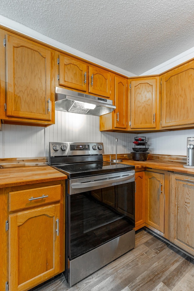 1602 Prater Rd, Chattanooga, TN 37412 - kitchen with under cabinet range hood, stainless steel electric range, a textured ceiling, dark wood finished floors, and brown cabinetry