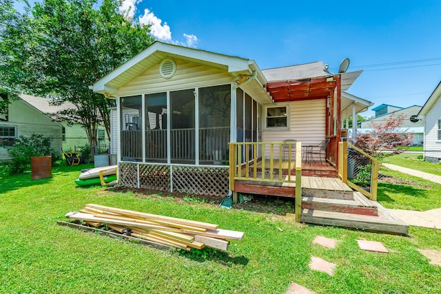 1602 Prater Rd, Chattanooga, TN 37412 - rear view of house featuring a sunroom, a yard, and a wooden deck
