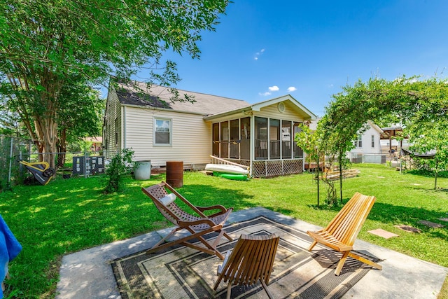 1602 Prater Rd, Chattanooga, TN 37412 - back of property featuring a sunroom, a patio, and a shingled roof