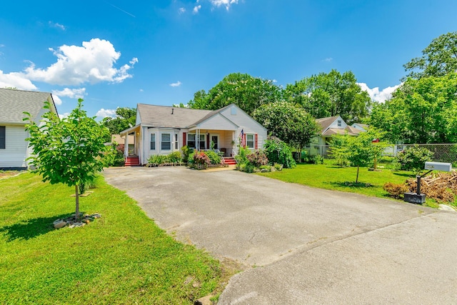 1602 Prater Rd, Chattanooga, TN 37412 - view of front of home featuring asphalt driveway, a porch, and a front yard