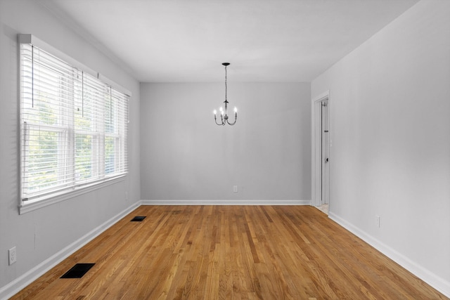 3671 Thrushwood Dr, Chattanooga, TN 37415 - unfurnished room featuring a chandelier, plenty of natural light, and light wood-type flooring