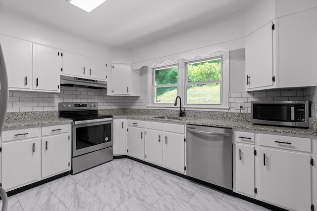 3671 Thrushwood Dr, Chattanooga, TN 37415 - kitchen featuring stainless steel appliances, under cabinet range hood, white cabinets, and light marble finish flooring