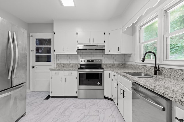 3671 Thrushwood Dr, Chattanooga, TN 37415 - kitchen with appliances with stainless steel finishes, under cabinet range hood, light marble finish floors, white cabinetry, and light stone counters