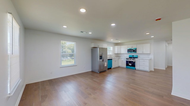 1150 Lang St NE, Cleveland, TN 37311 - kitchen with appliances with stainless steel finishes, white cabinetry, light countertops, recessed lighting, and light wood-style floors