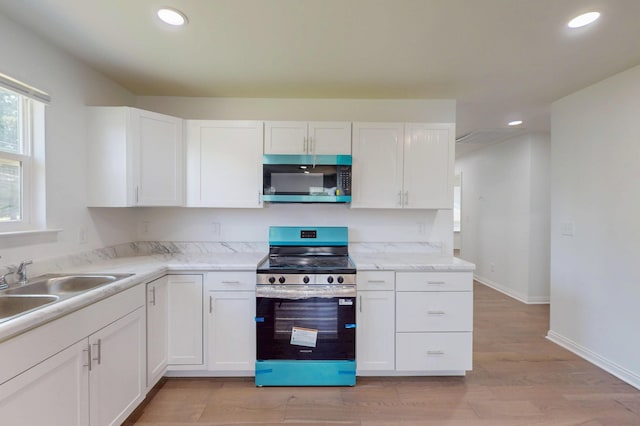 1150 Lang St NE, Cleveland, TN 37311 - kitchen featuring appliances with stainless steel finishes, white cabinetry, light wood-type flooring, recessed lighting, and light countertops