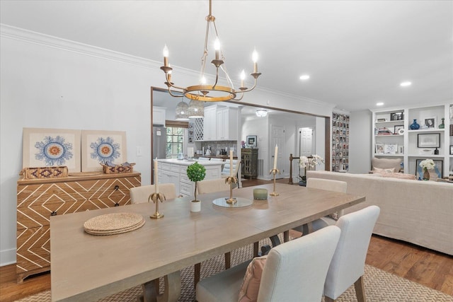 110 Linden St, Lookout Mountain, TN 37350 - dining space with ornamental molding, a chandelier, wood finished floors, built in shelves, and recessed lighting