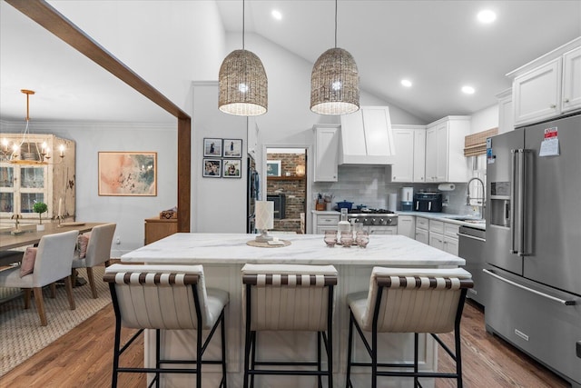 110 Linden St, Lookout Mountain, TN 37350 - kitchen featuring stainless steel appliances, lofted ceiling, tasteful backsplash, white cabinets, and light stone counters